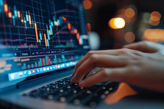 A financial analyst works with real-time stock data on a multi-monitor computer. photo