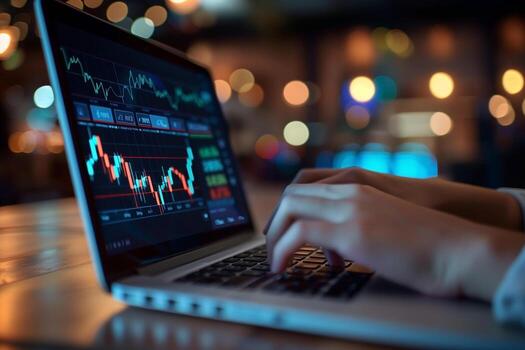 A financial analyst works with real-time stock data on a multi-monitor computer. photo