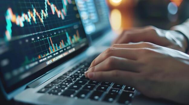 A financial analyst works with real-time stock data on a multi-monitor computer. photo