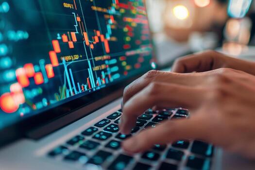 A financial analyst works with real-time stock data on a multi-monitor computer. photo