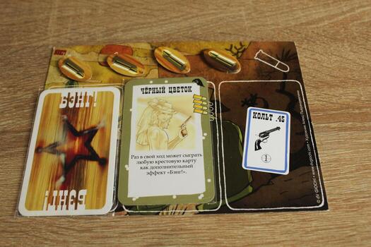 Mozyr, Belarus, April 01 2024. board card game bang. Maps and game elements on the tablet. Rules of the game photo