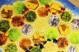 Mozyr, Belarus, April 01 2024. board game catan colonizers. A tiger field with players' chips, top view. Family Fun photo