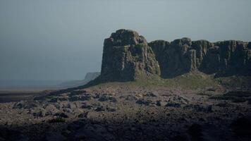 A large rock formation in the middle of a desert video