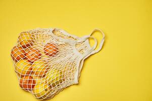 Replacing plastic bags. Taking care of the environment. Grid with fruit on colored paper, fortification. Minimalism. photo