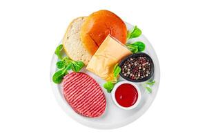 raw burger set cutlet, bun, cheese, tomato sauce, greens fresh cooking appetizer meal food snack on the table copy space food background rustic photo