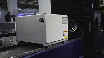 Automated laser cutting machine for metal pipes. Media. Moving machine on rails of industrial conveyor. Automated laser machine moving in industrial workshop photo