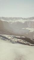 row of sharp dark cliffs standing out from the snow video