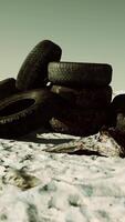 old tires overgrown embedded in the sand video
