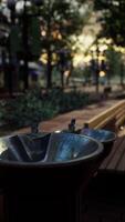 closeup of a drinking water fountain in a park on sunset video