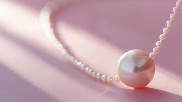 Single pearl necklace on a blush pink background with ample copyspace, timeless elegance photo
