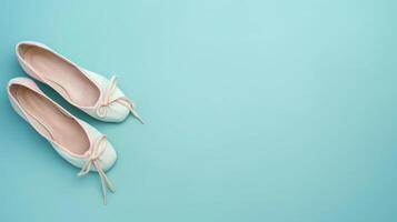 Pair of ballet shoes on a powder blue background with ample copyspace, elegant design photo