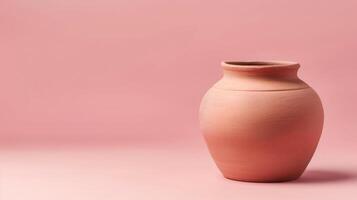 Handmade clay pot on a millennial pink background with ample copyspace, perfect for design photo