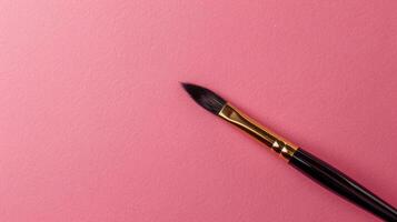 Calligraphy brush on a dusty rose background with ample copyspace, blending tradition and elegance photo