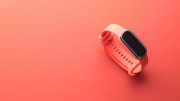 Trendy fitness tracker on a soft coral background with ample copyspace for creative projects photo