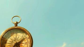 Artistic old compass on a sky blue background with generous copyspace photo