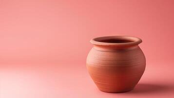 Millennial pink background featuring a handmade clay pot, ideal for copyspace photo