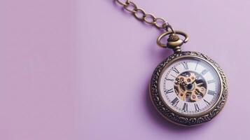 Artistic old pocket watch on a soft lilac background with abundant copyspace photo