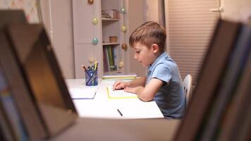 Boy Reading a Book at a Table in His Room video