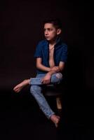 boy posing on a black background . close-up photo