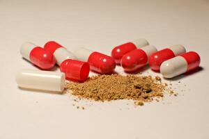 open tablet.tablet contents. white and red tablets. close-up . the concept of health, treatment. photo