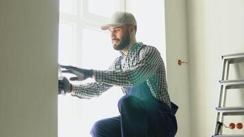 Man plasterer construction worker at work, plastering the wall inside the building site of a house video