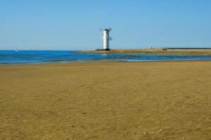 Old lighthouse in Swinoujscie, a port in Poland on the Baltic Sea. The lighthouse was designed as a traditional windmill. Panoramic image. old mill. lighthouse photo