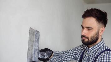 Man plasterer construction worker at work, plastering the wall inside the building site of a house video