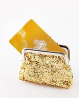Gold wallet with gold credit card on white background photo
