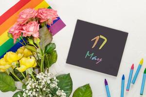 Roses on a rainbow flag and chalkboard with inscription 17 May photo