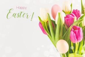 Spring bouquet of tulips with decorative easter eggs photo