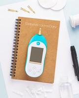 Diabetic disease concept with Glucose meter and diary of control photo