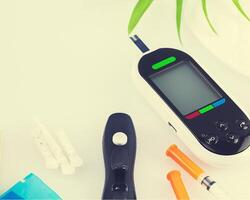 Diabetes control concept with glucose meter and copy space photo