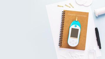 Diabetic disease concept with Glucose meter and diary of control photo