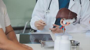 Doctor and nurse examining patient's medical records and medical team working on the background video
