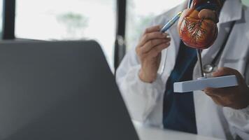 Doctor and nurse examining patient's medical records and medical team working on the background video