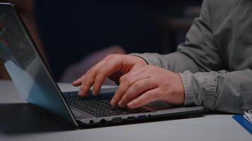 Close-up of businessman hands on keyboard sitting at desk table in startup company office browsing economic ideas on internet. Entrepreneur typing financial statistics answering business email video