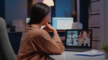 Overworked businesswoman discussing with remote partners on laptop while having online videocall teleconference meeting. Manager talking marketing strategy during company conference in startup office video