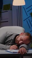 Exhausted overworked businessman sleeping on desk table in startup business office after analysing financial statistics late at night. Workaholic tired manager working at economic deadline project video