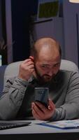 Entrepreneur man chatting with company teamwork on phone planning management meeting discussing economic strategy during teammeeting videocall. Businessman working late at night in startup office video