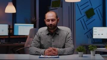 Pov of exhausted businessman discussing with remotely colleague working at financial digital project deadline during videocall conference meeting. Tired entrepreneur working in startup company office video