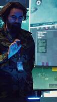 Vertical Infantry unit leader studies satellite imagery on a holographic image, working with high tech holograms to create the mission details for the troops. Ways to attack hostile vessels at sea. Camera A. video