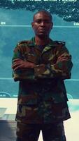 Vertical Portrait of confident military general wearing camo uniform in mission control center, overseeing operations regarding the national safety and protocol. Federal army base command post. Camera B. video