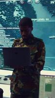 Vertical National guard machinist managing cybersecurity measures to protect federal government data from enemy breaches. Army troop conducting reconnaissance or demining operations. Camera B. video