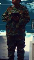 Vertical Woman sergeant major working on deployment of electronic warfare tools to disrupt enemy communications. Female army soldier with camouflage uniform operating on high tech gear. Camera B. video