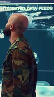 Vertical Commander managing cybersecurity measures to protect federal data from enemy breaches, working with his crew from a control center military base. Army officer ensures national safety. Camera B. video
