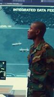 Vertical Major general updating and maintain the command center databases with current operational data, monitoring surveillance radar footage to ensure national safety. Control room. Camera B. video