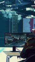 Vertical Army personnel applying national safety protocols by verifying all ships anchoring in the coastal ports, using radar surveillance on big screen in military command post. Federal operations. Camera B. video