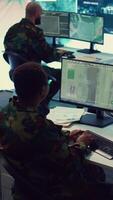 Vertical Army officer establishing new operating bases through a world map satellite vision, ensure the connectivity to the power base command center. Commander operates CCTV radar footage. Camera B. video