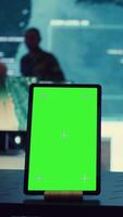 Vertical General headquarters monitoring room with a mockup screen on tablet, army officers safeguarding the coast line from enemy vessels. National guard machinists in control center. Camera B. video