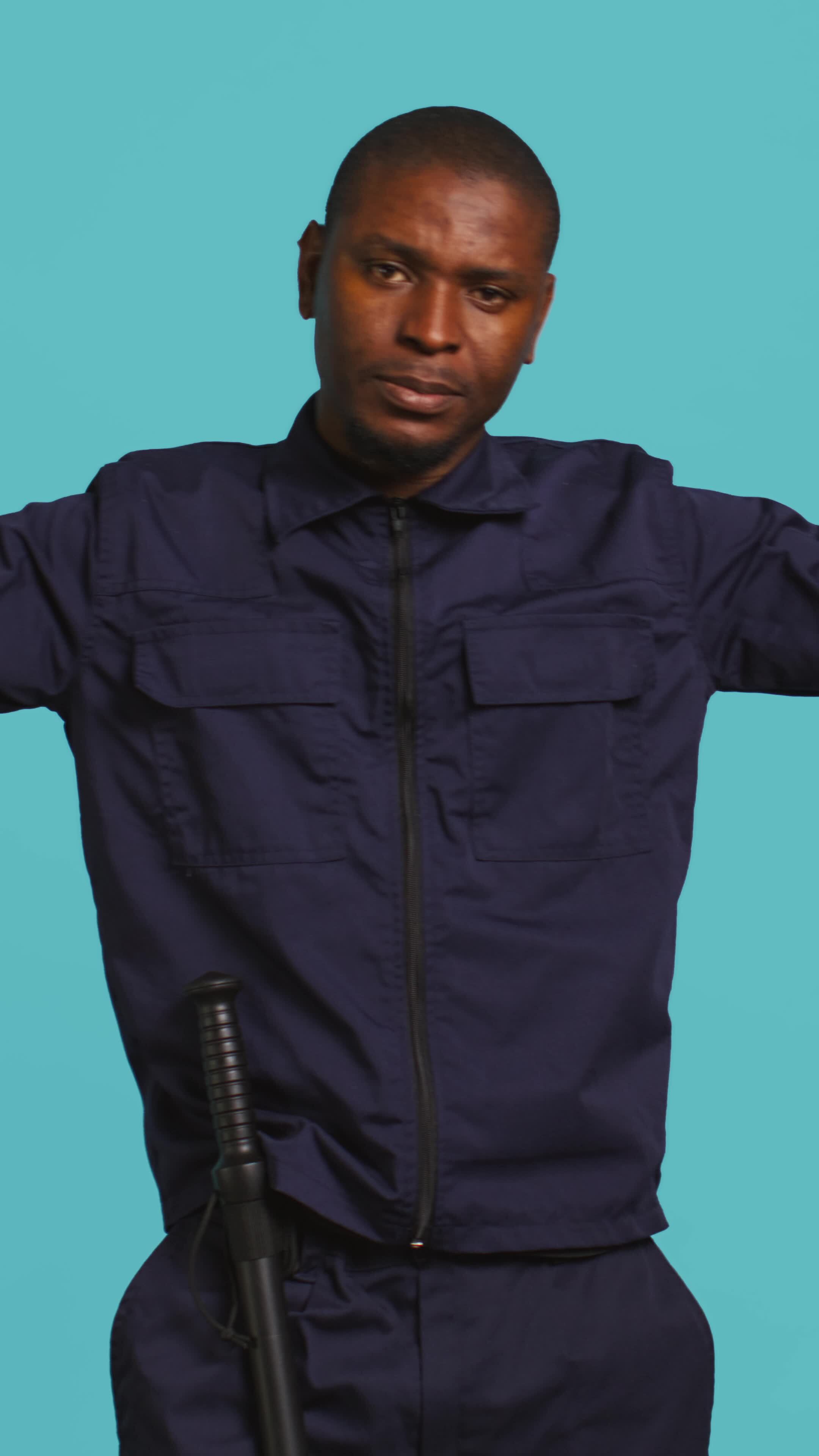 Vertical Security guard doing thumbs down sign gesturing, denying